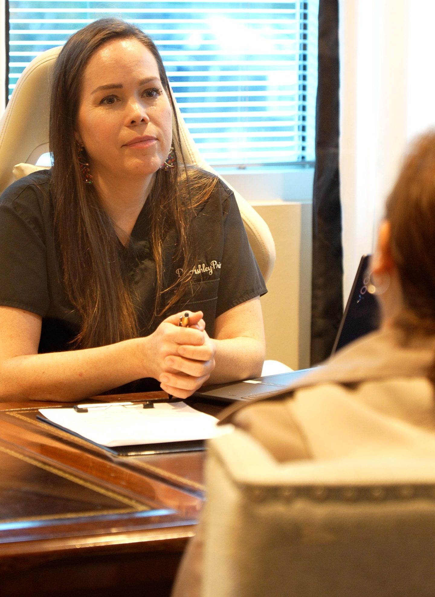 Dr. Ashley Prince, DC, meeting with a patient at Prince Health in The Woodlands, Texas